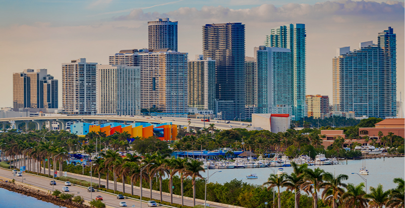 Aerial view of Downtown Miami skyline with palm trees and marina