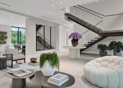 Luxury interior with modern living room featuring high ceilings and elegant staircase